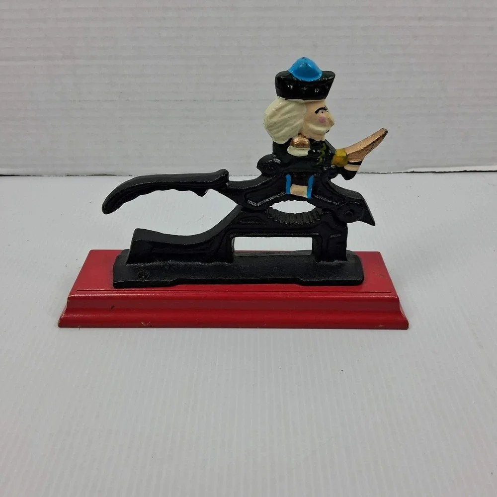 Vintage Cast Iron Mechanical Nutcracker Soldier Figure on Red Wood Base Black
